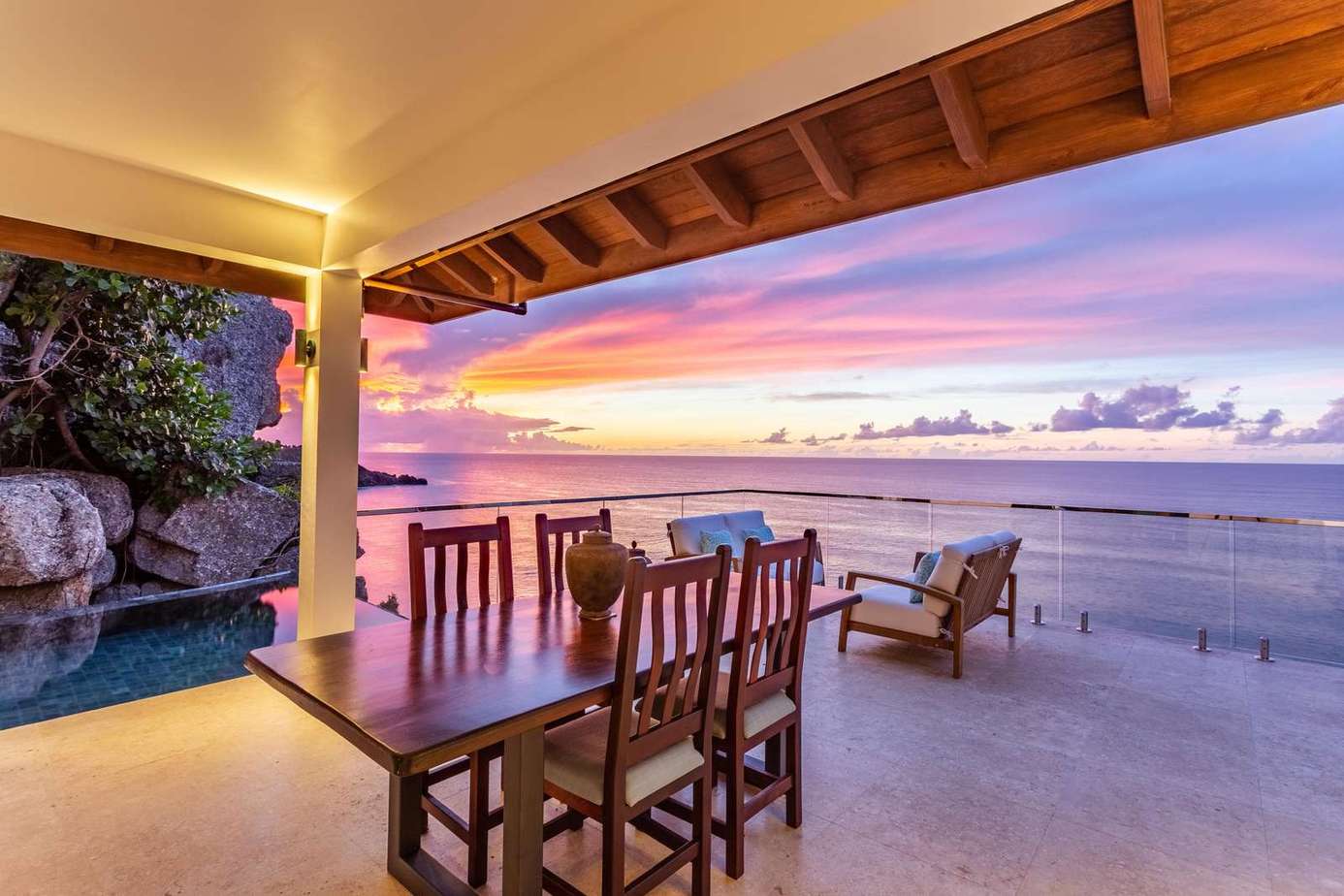 Oceanfront patio with stunning sunset and cozy seating