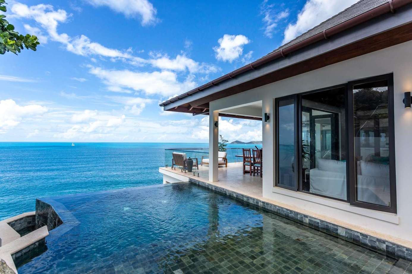 Infinity pool with stunning ocean views and modern patio