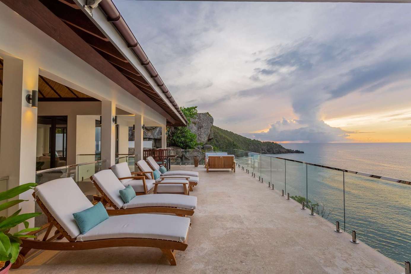 Oceanfront patio with loungers and sunset views