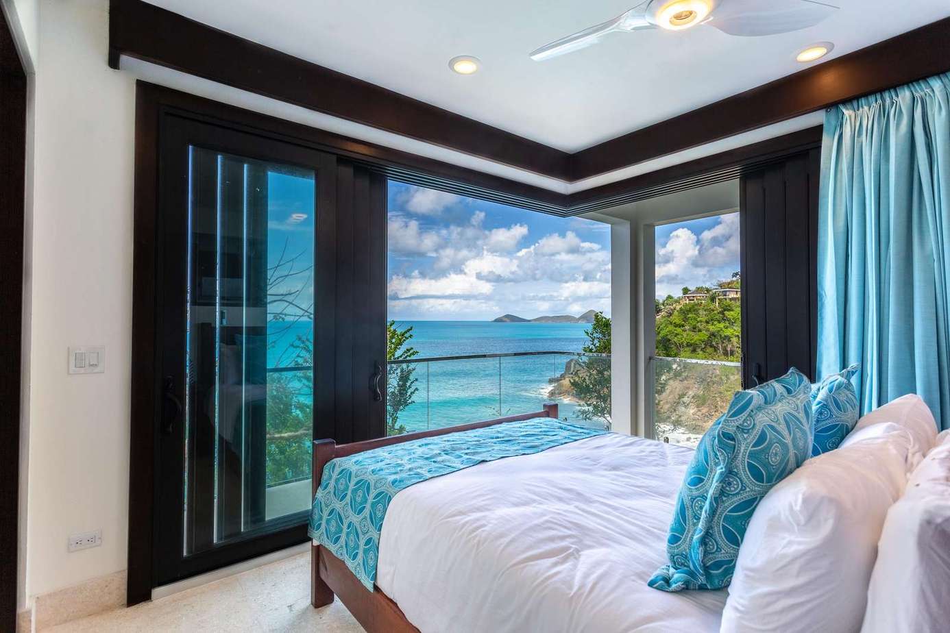 Oceanfront bedroom with panoramic water views and fresh sea breeze