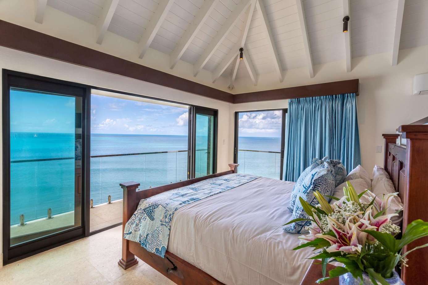 Oceanfront bedroom with panoramic water views and serene ambiance