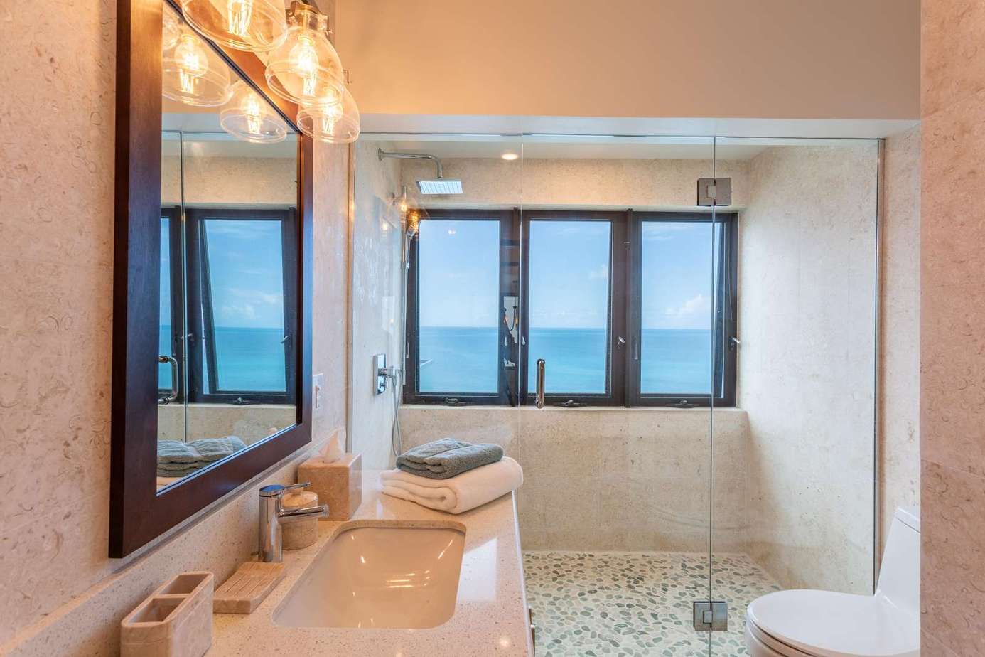 Bright bathroom with spacious walk-in shower and ocean views