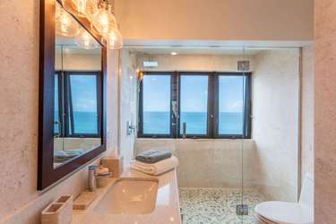 Bright bathroom with spacious walk-in shower and ocean views