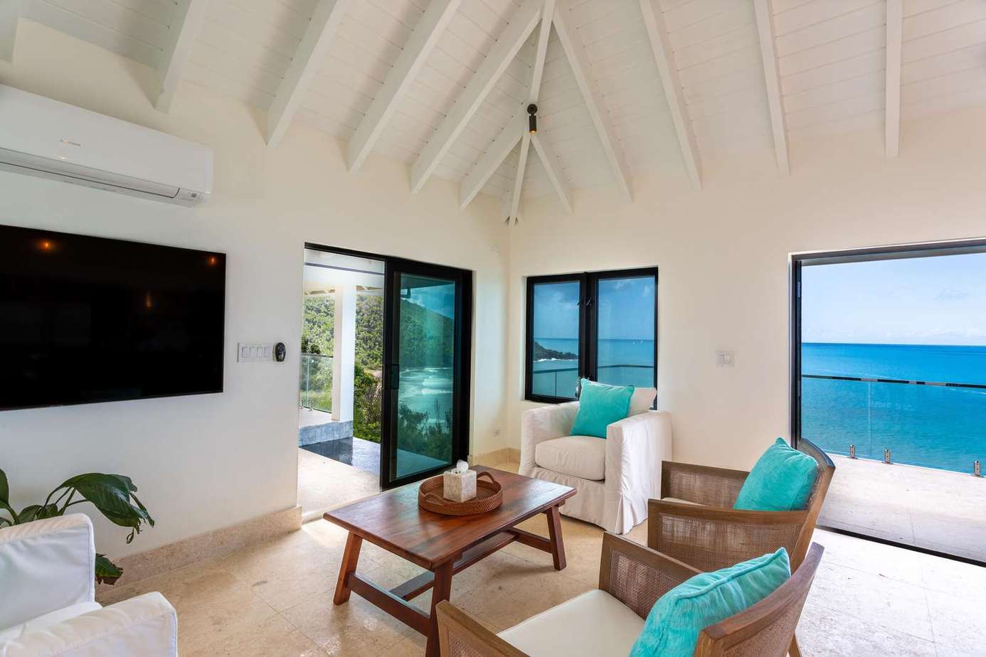 Bright living room with stunning ocean views and vaulted ceilings