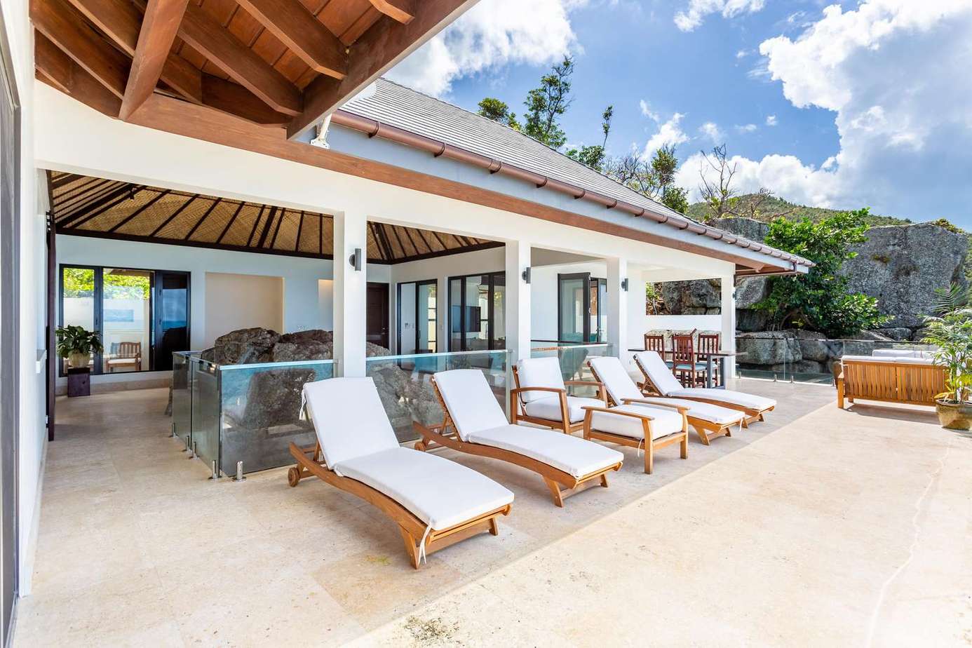 Spacious patio with loungers and ocean views for ultimate relaxation