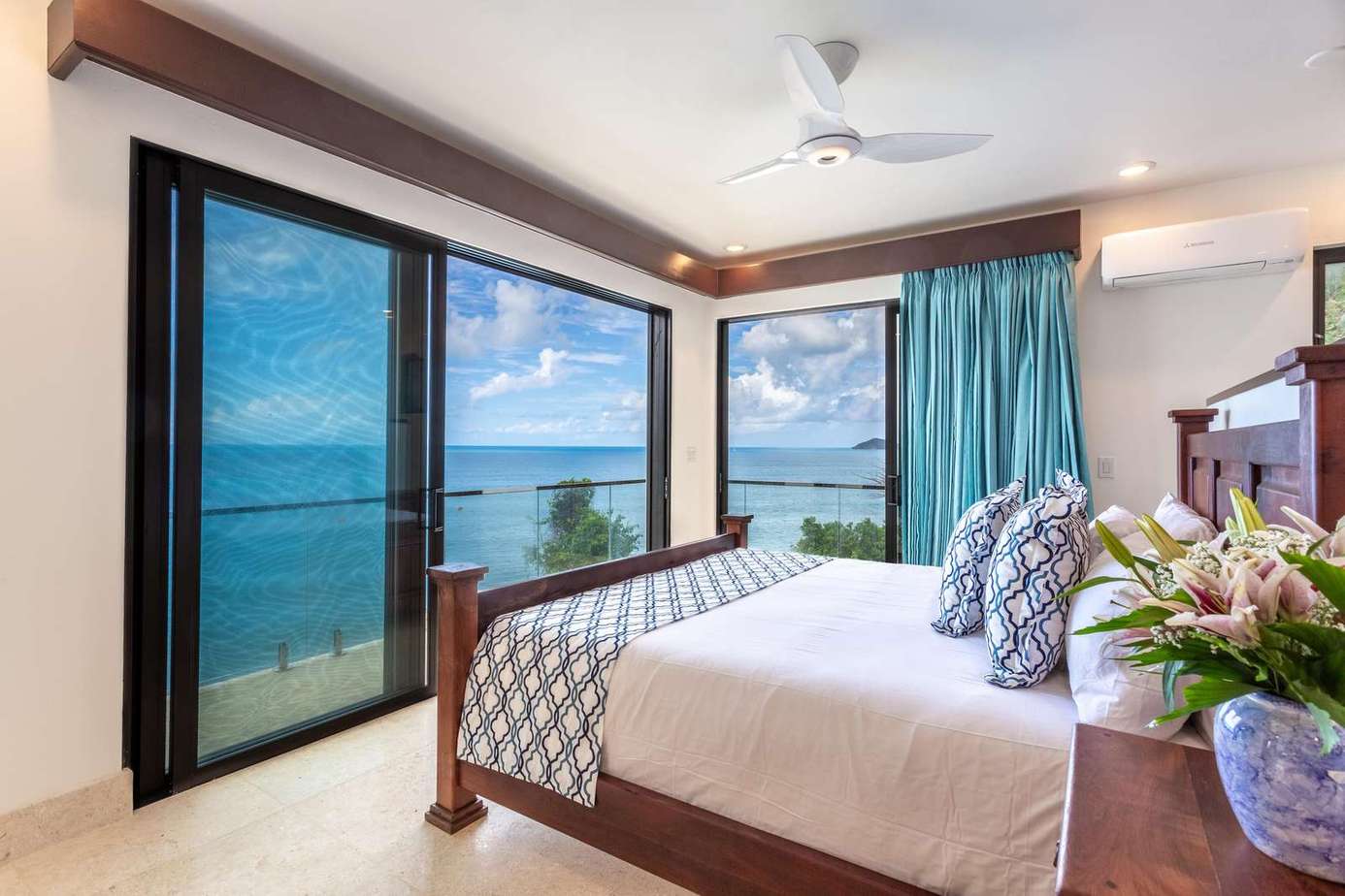 Oceanfront bedroom with panoramic water views and serene ambiance