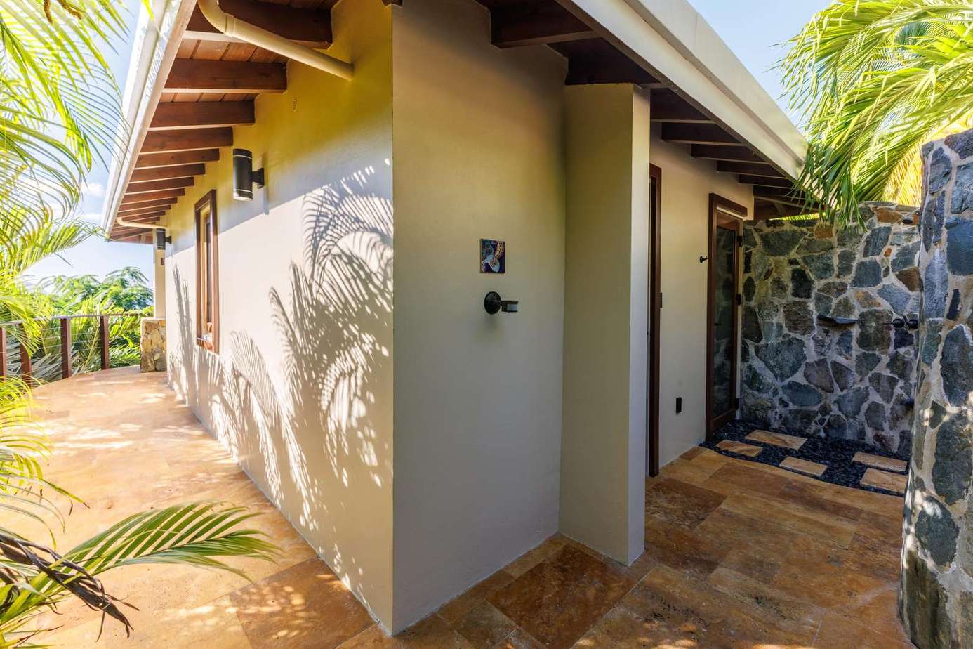 Secluded outdoor shower oasis surrounded by tropical greenery