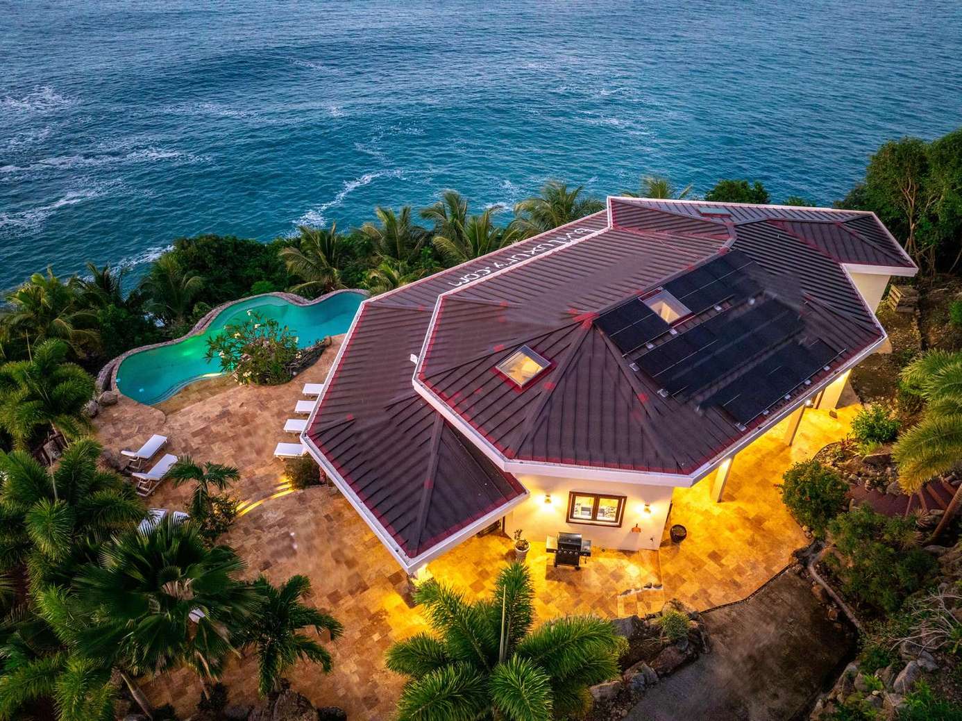 Secluded oceanfront villa with private pool and lush greenery