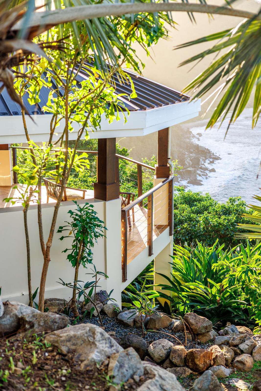 Secluded patio surrounded by lush tropical greenery and ocean views