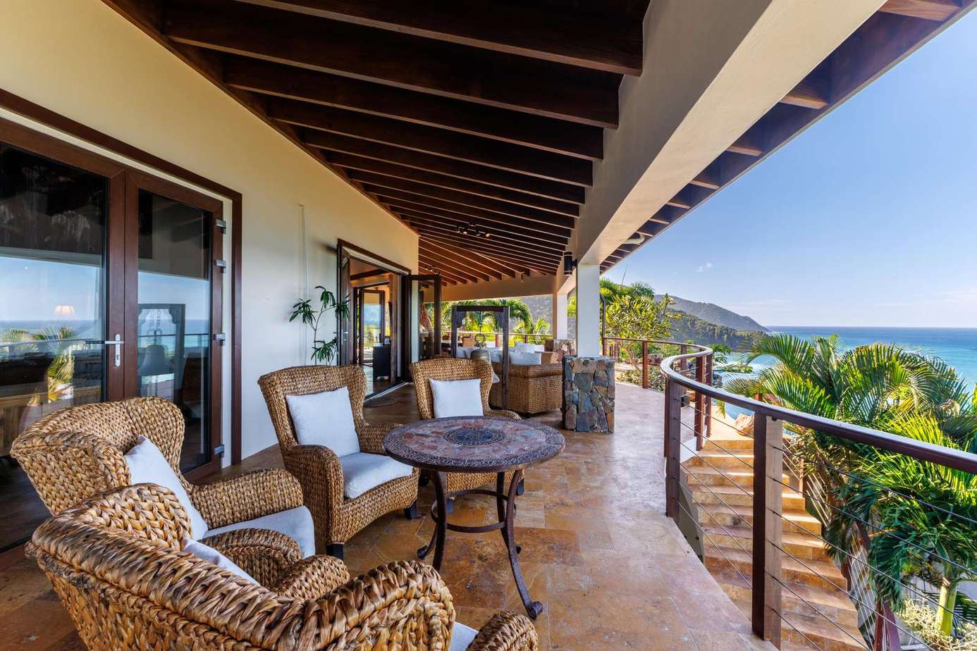 Spacious ocean-view patio with cozy seating for sunset relaxation