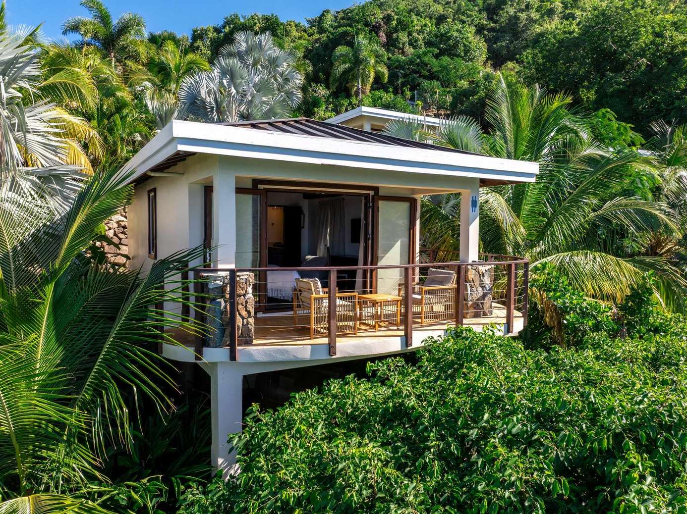Secluded balcony retreat surrounded by lush tropical greenery