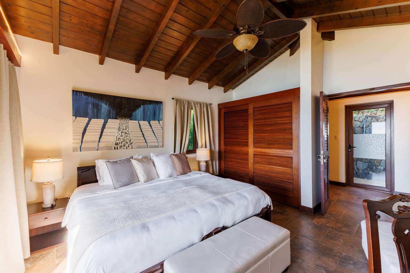 Cozy bedroom retreat with vaulted ceilings and natural light