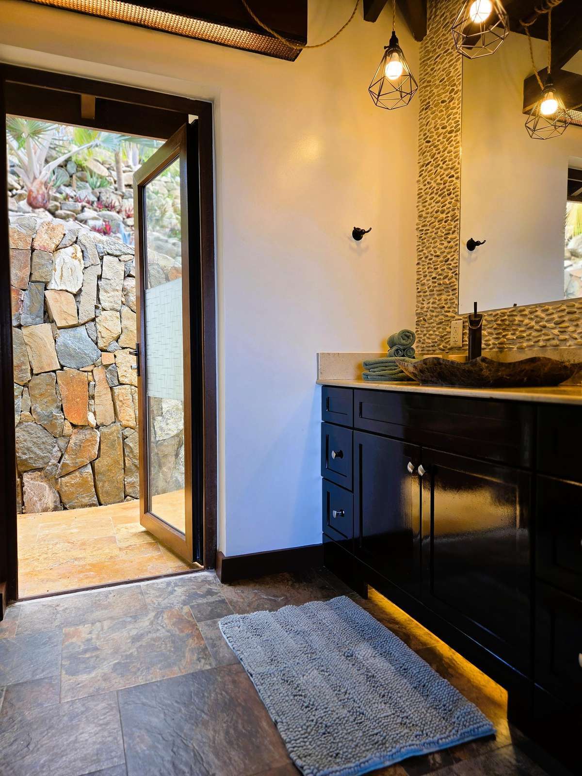 Cozy bathroom retreat with rustic stone entryway and warm lighting