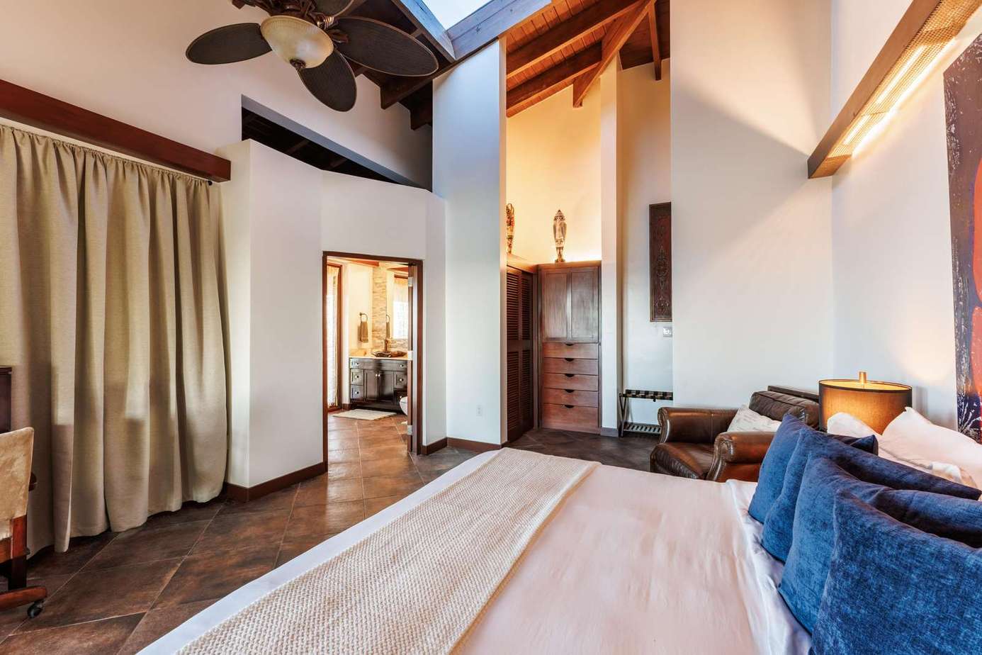 Spacious bedroom with vaulted ceilings and cozy fireplace