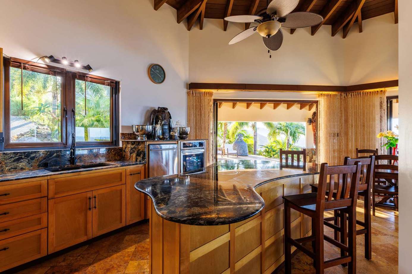 Sunlit kitchen with granite island and rustic charm
