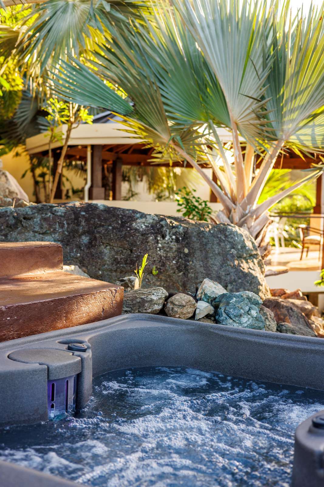 Private hot tub oasis surrounded by lush tropical greenery