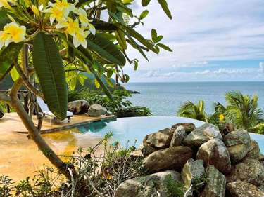 Serene infinity pool with stunning ocean views and lush greenery