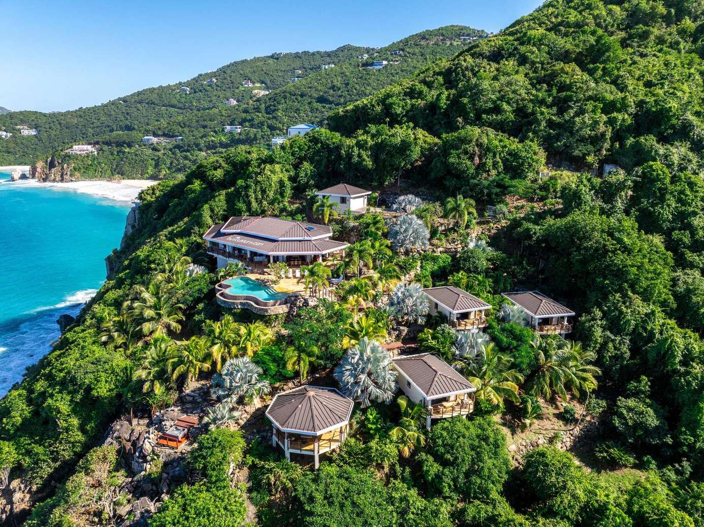 Secluded hillside villas with stunning ocean views and lush greenery