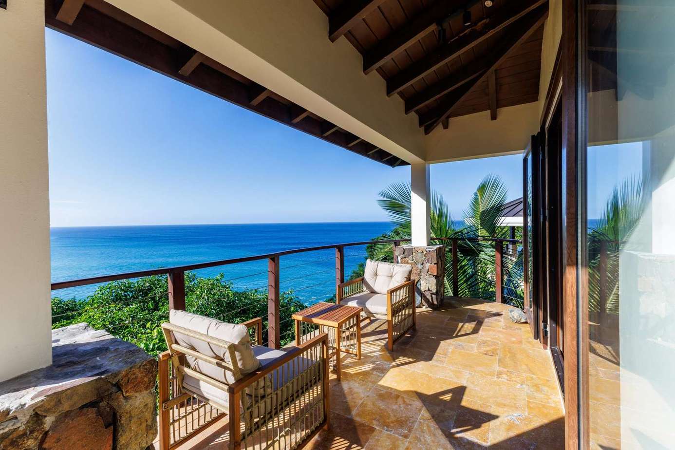 Oceanfront patio with cozy seating and stunning views