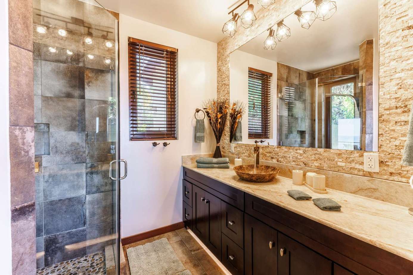 Spa-inspired bathroom with modern glass shower and elegant stone accents