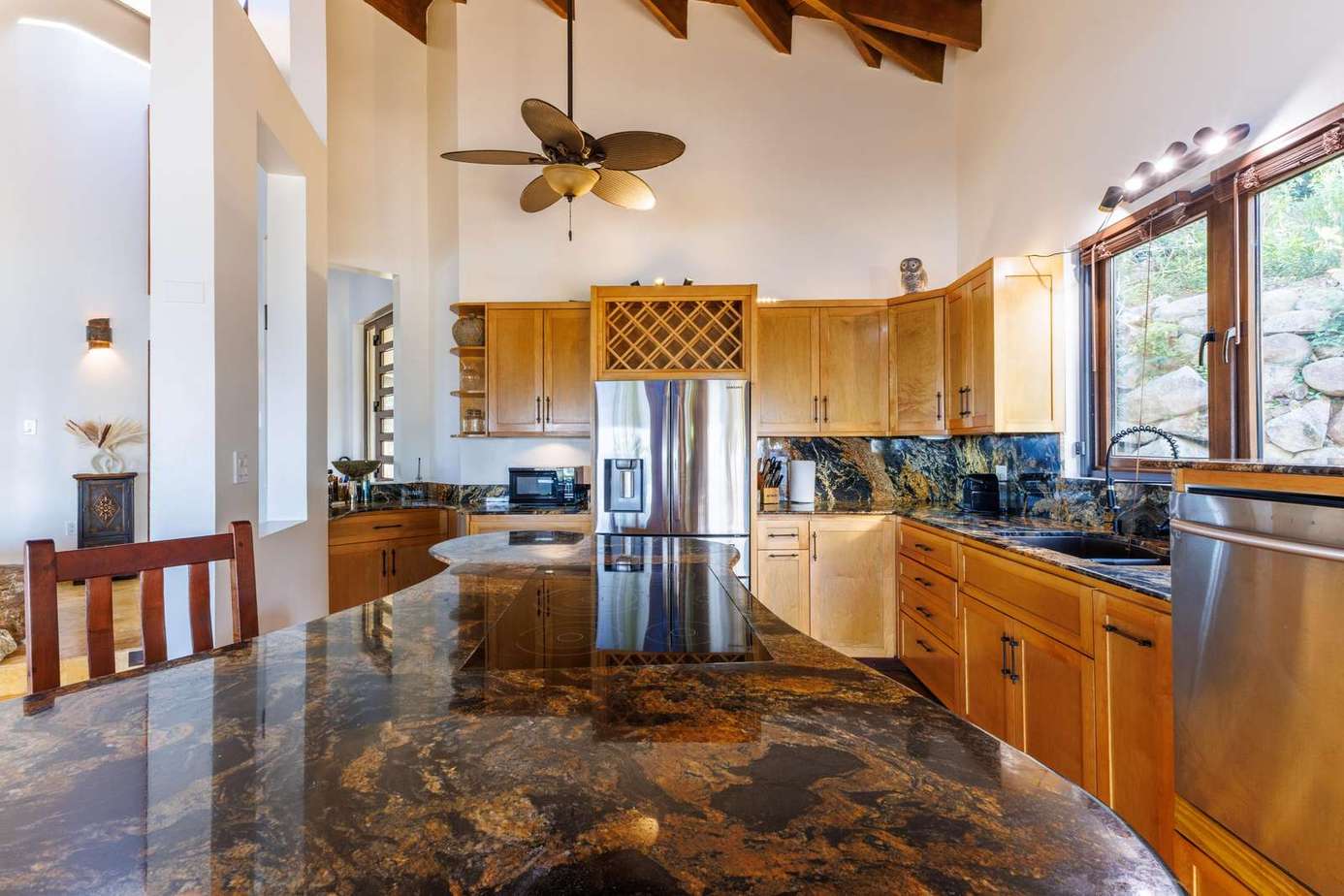 Spacious kitchen with granite island and vaulted ceilings