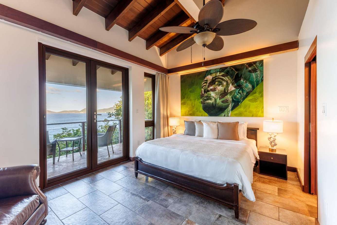 Sunlit bedroom with vaulted ceilings and ocean views