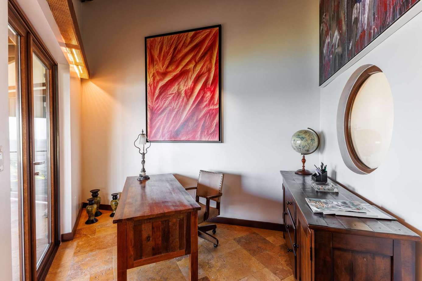 Sunlit home office with inspiring art and vintage charm