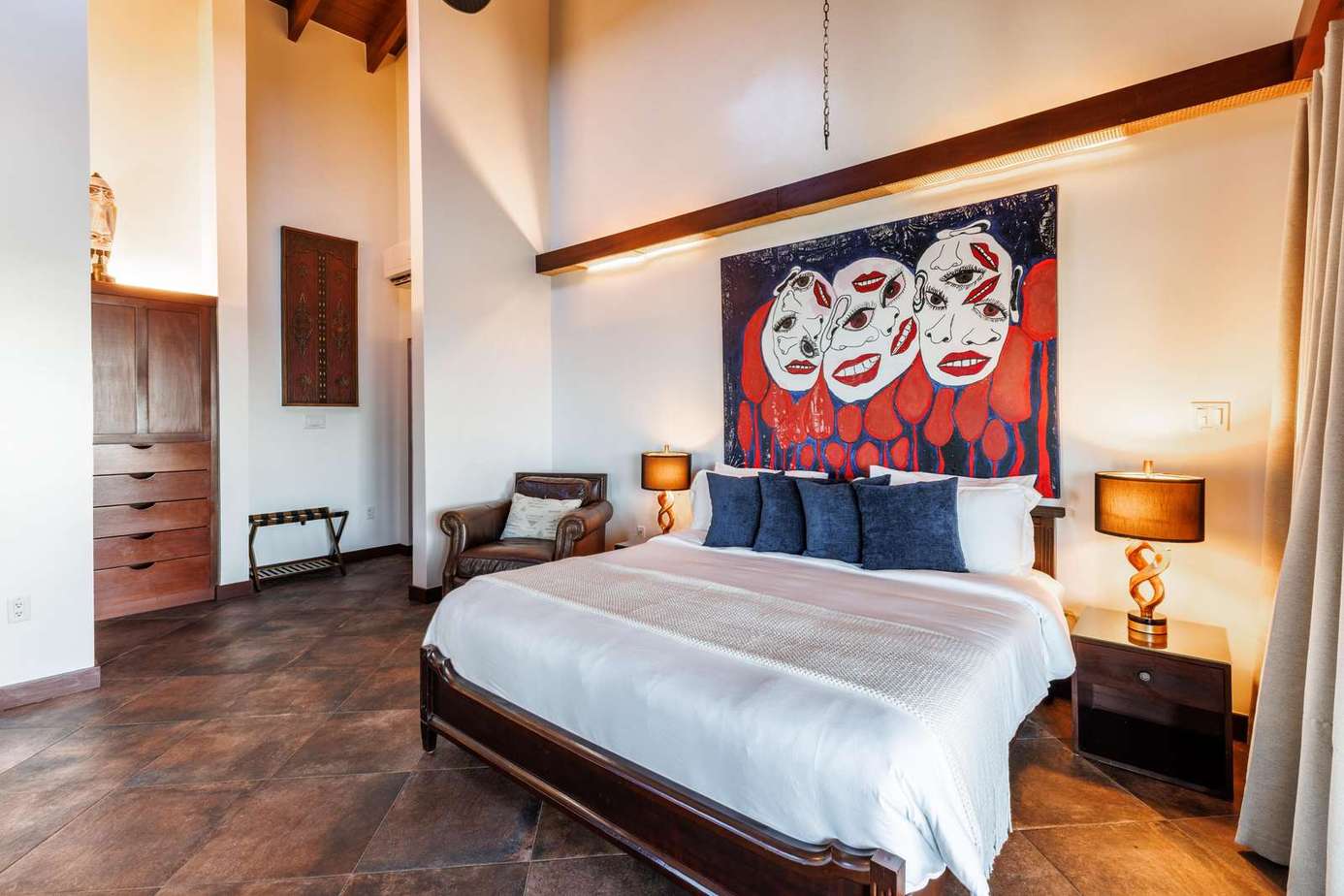 Spacious bedroom with vaulted ceilings and vibrant artwork