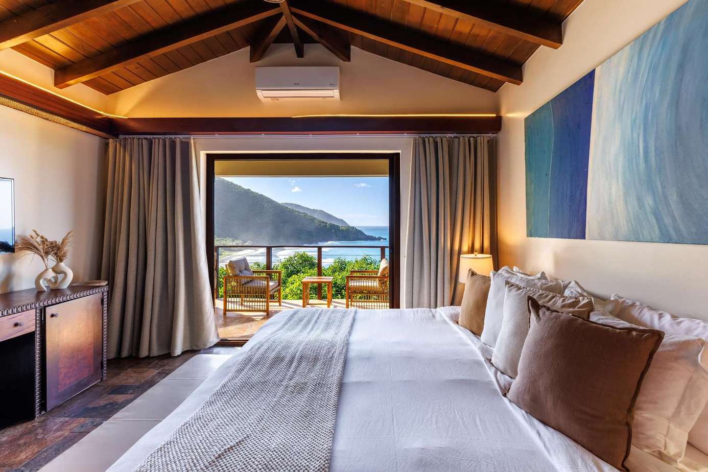 Cozy bedroom with vaulted ceilings and mountain views