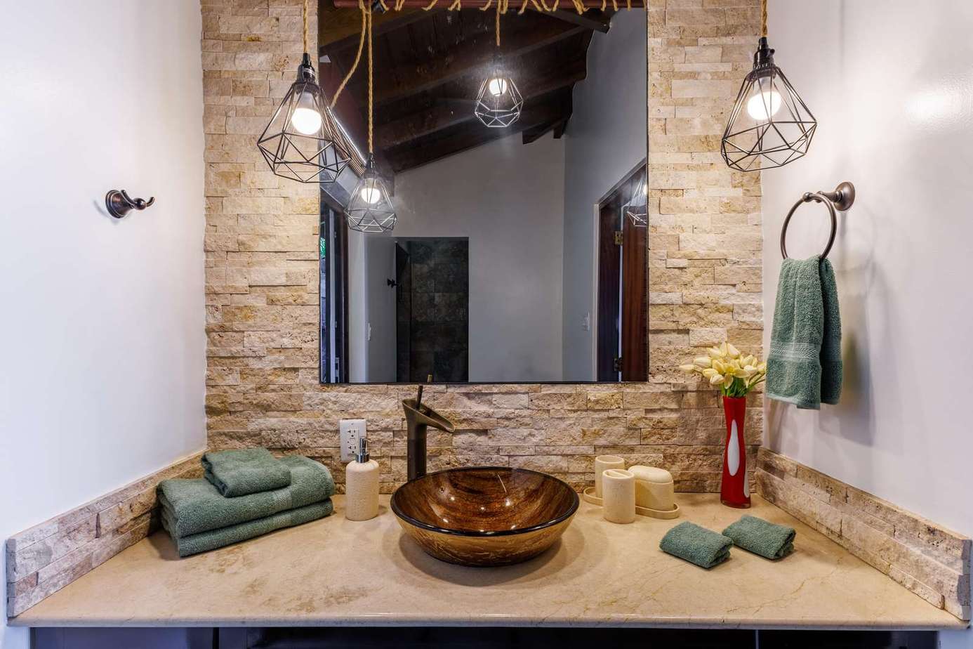 Rustic bathroom retreat with warm stone and ambient lighting