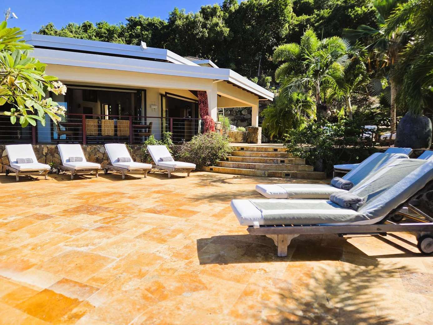 Sun-drenched patio with ample lounge seating for relaxation