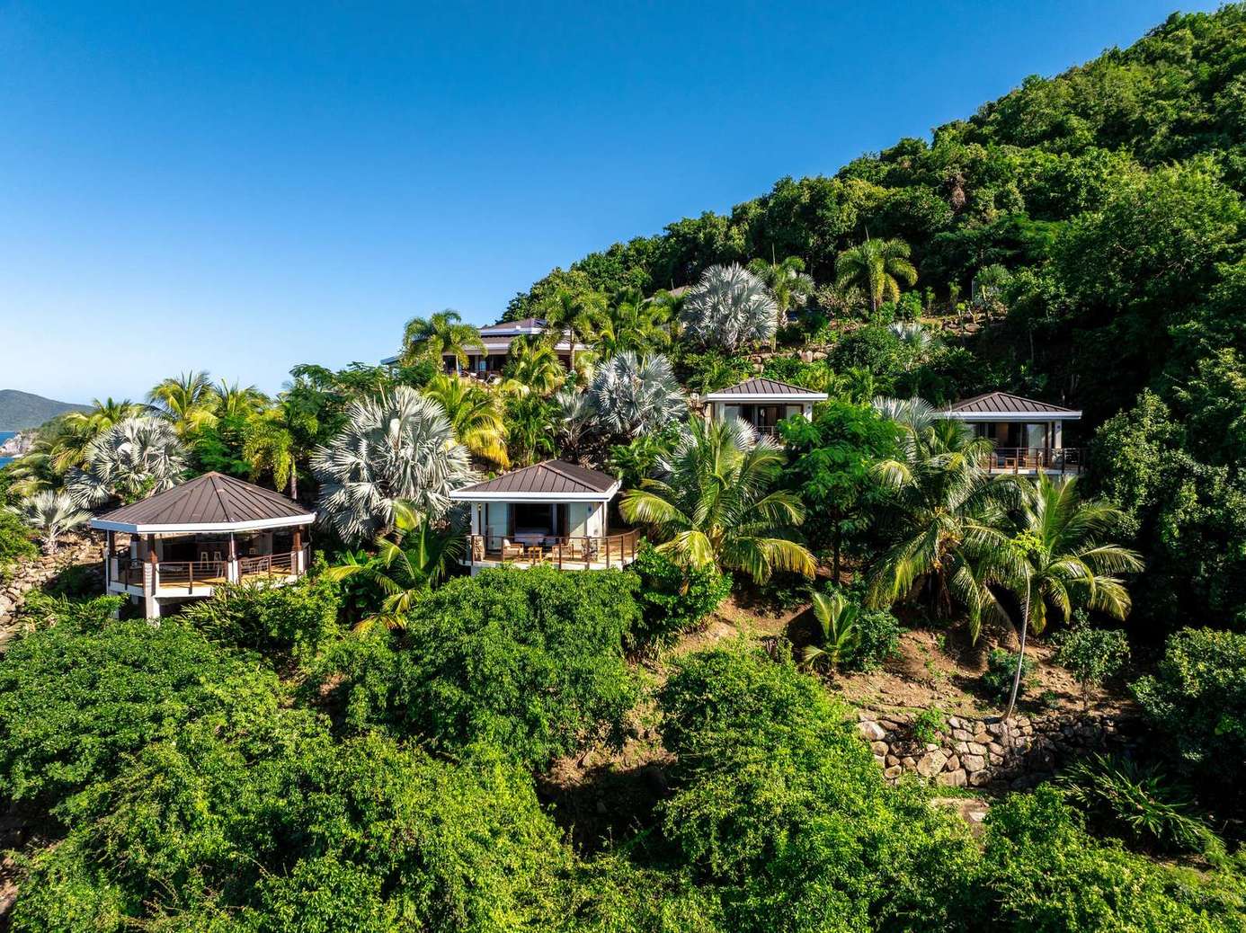 Secluded hillside villas surrounded by lush tropical greenery