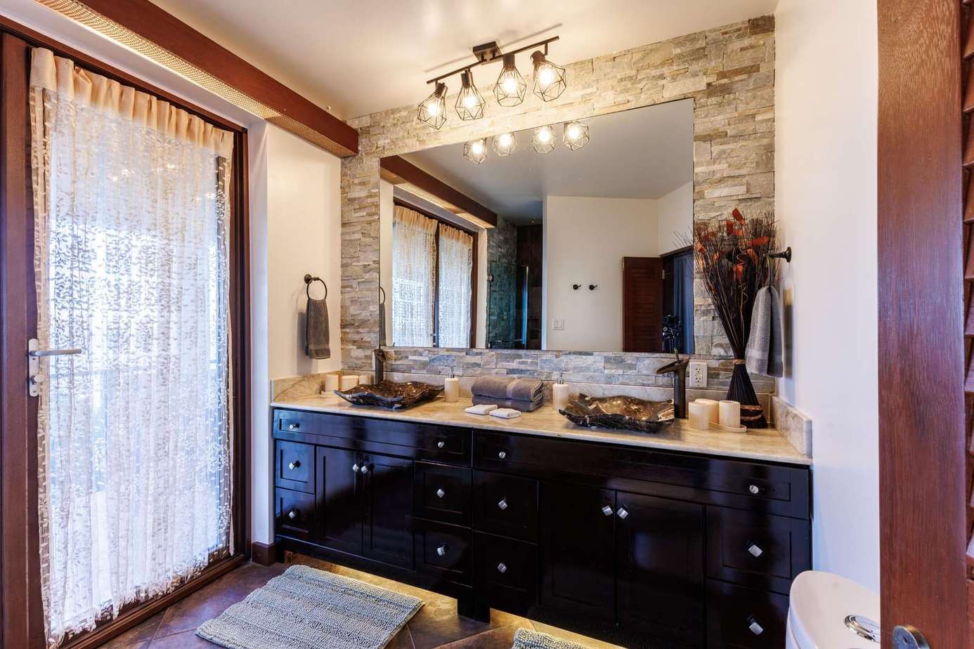 Spacious bathroom with elegant stone accents and natural light