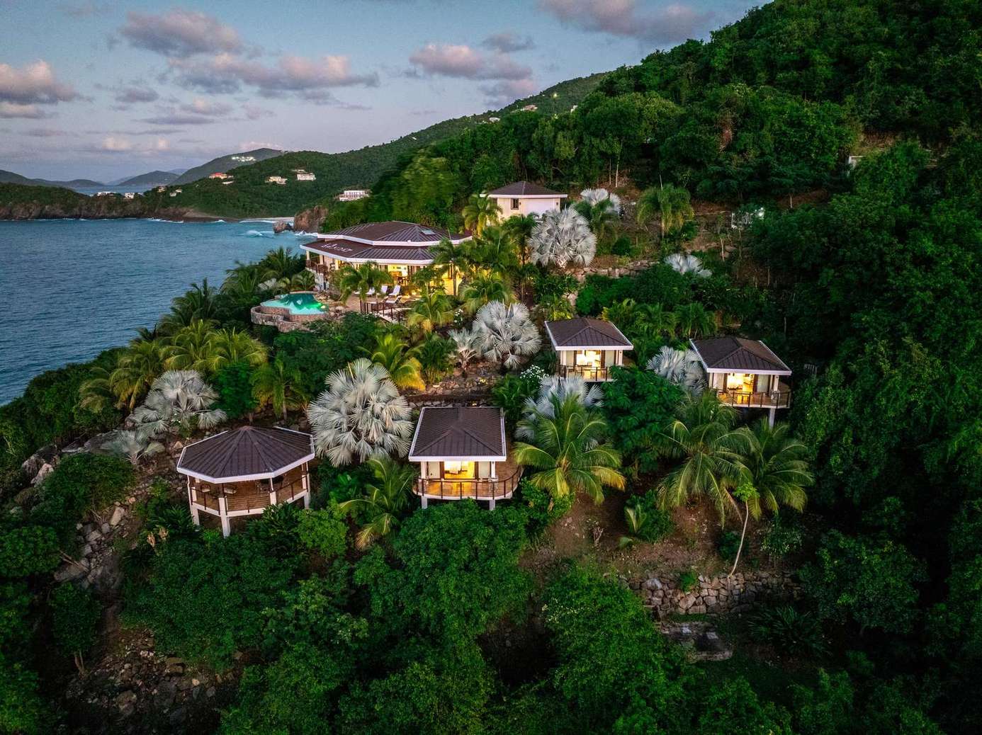 Secluded hillside villas with stunning ocean views and lush greenery