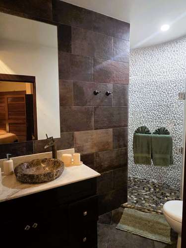 Modern bathroom retreat with elegant stone accents and warm lighting