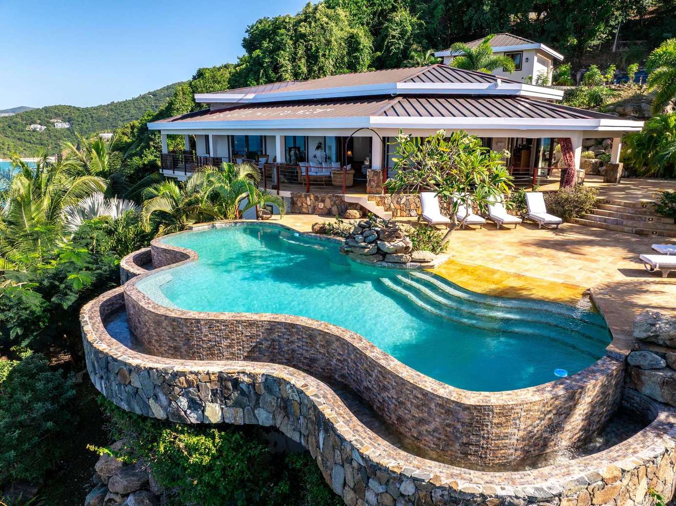 Stunning infinity pool with panoramic hillside views and spacious patio