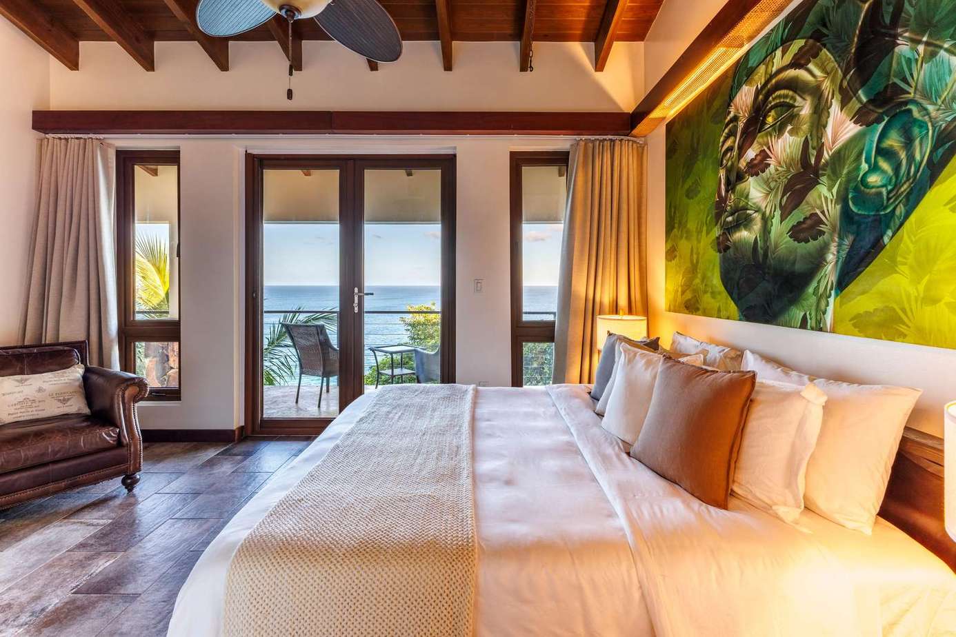 Spacious bedroom with ocean views and tropical decor