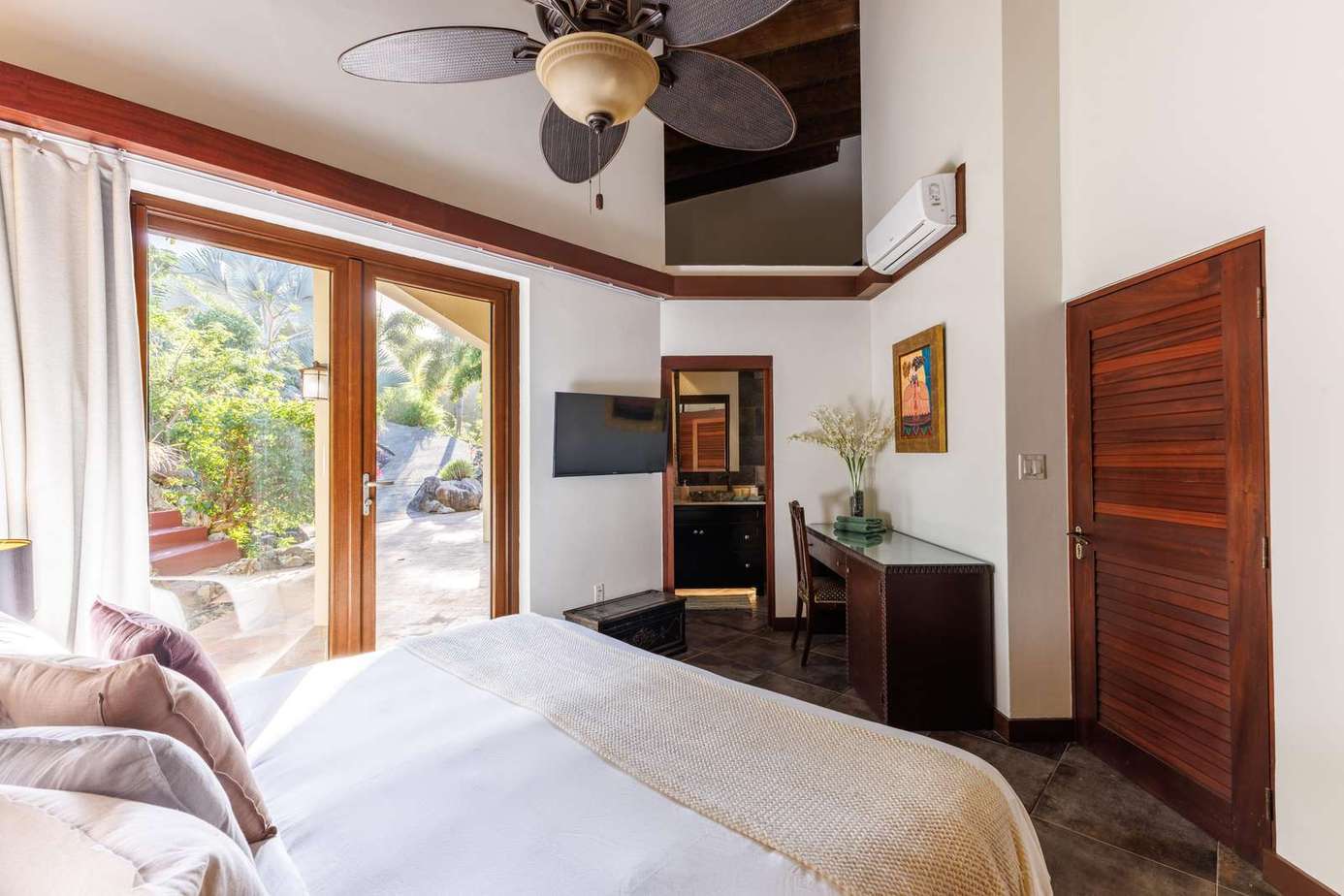 Sunlit bedroom with private patio and cozy fireplace