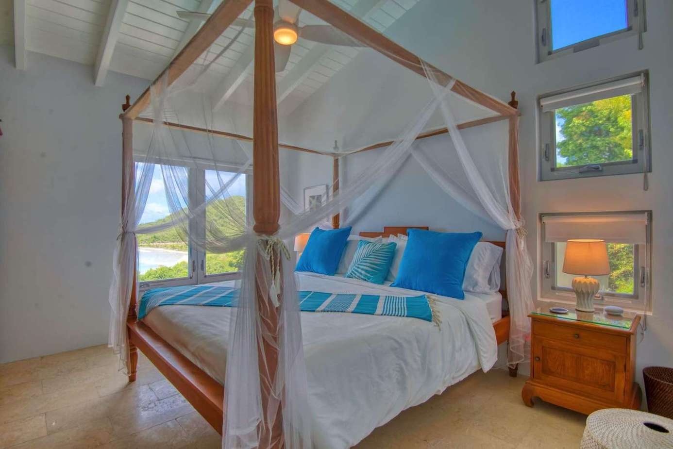 Airy bedroom with vaulted ceilings and cozy canopy bed
