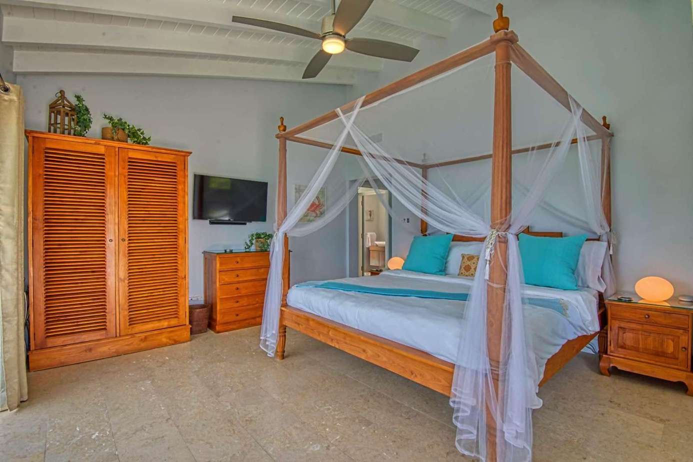 Airy bedroom retreat with cozy canopy bed and vibrant accents