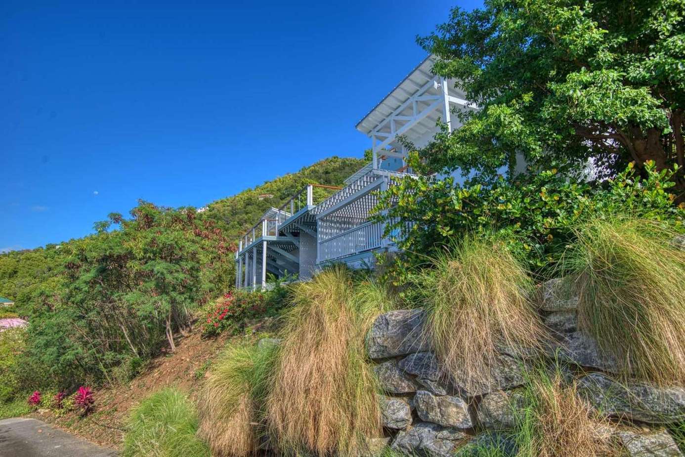 Secluded hillside retreat with panoramic blue sky views