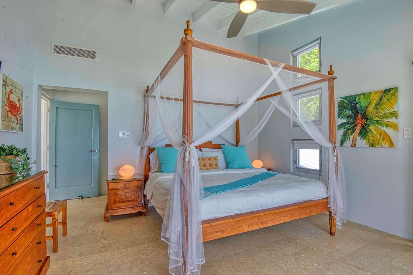 Airy bedroom retreat with a cozy four-poster bed and tropical accents