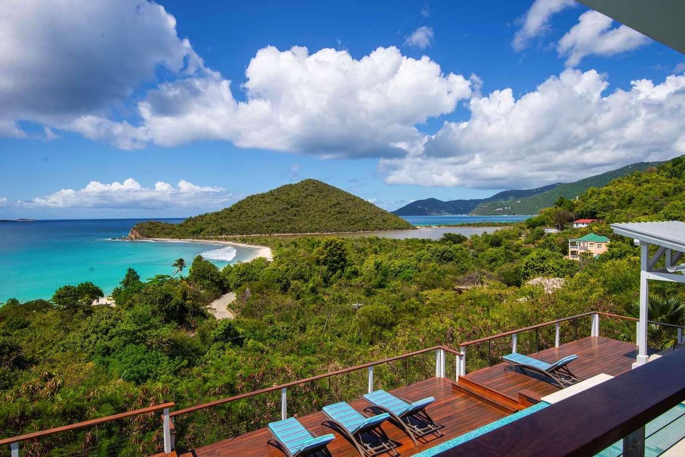 Oceanfront deck with panoramic views and lounge chairs