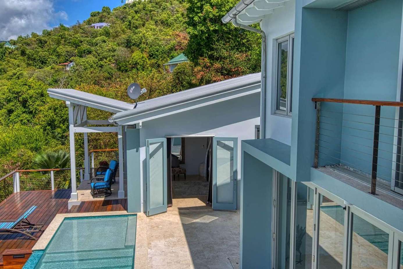 Modern patio retreat with pool and hillside views