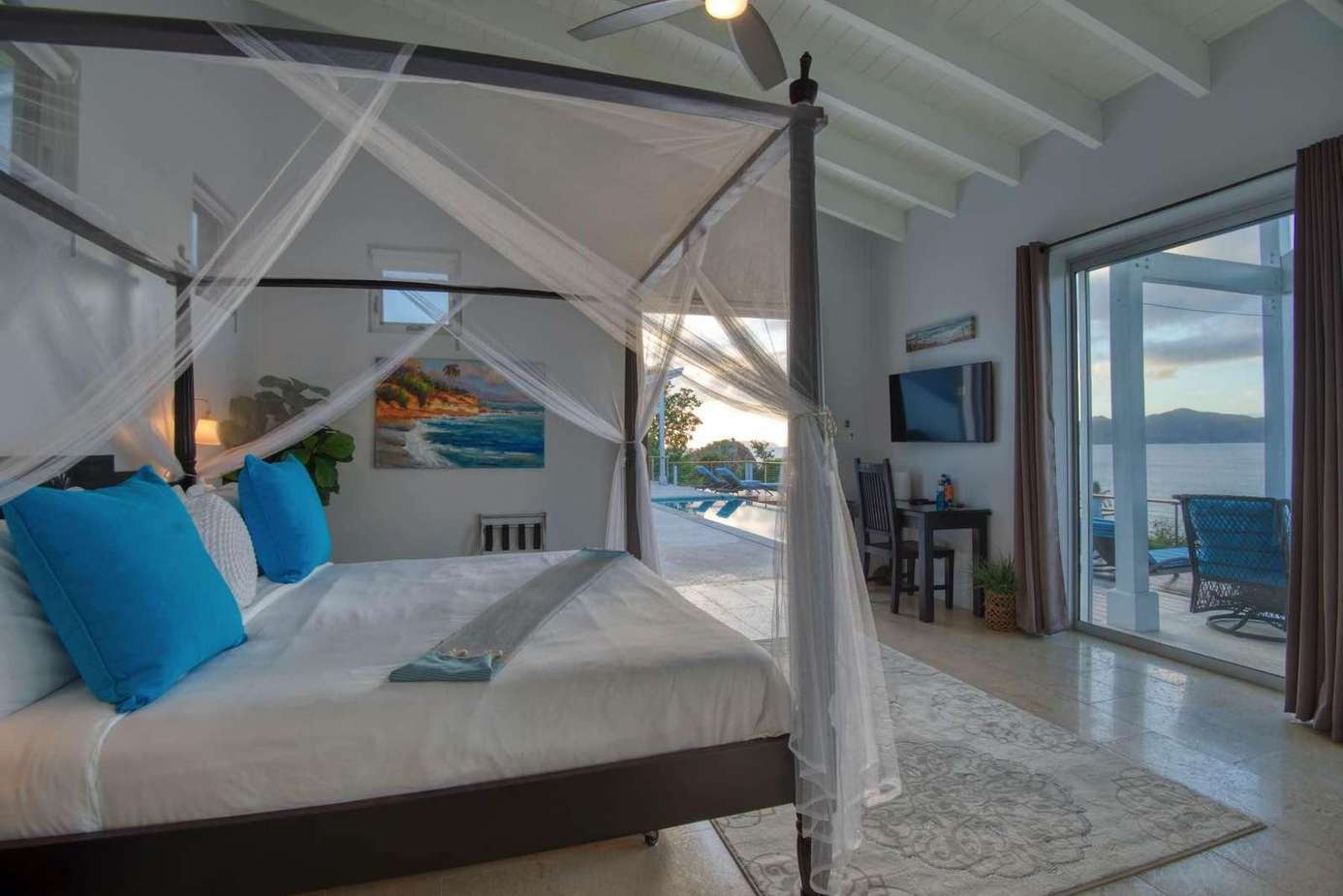 Airy bedroom with ocean views and cozy seating nook