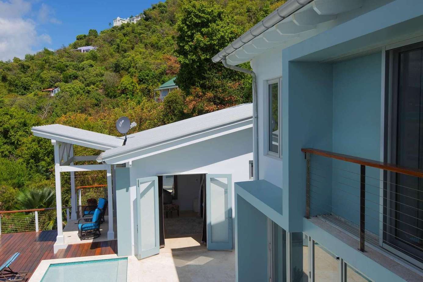 Sunlit balcony retreat with lush hillside views
