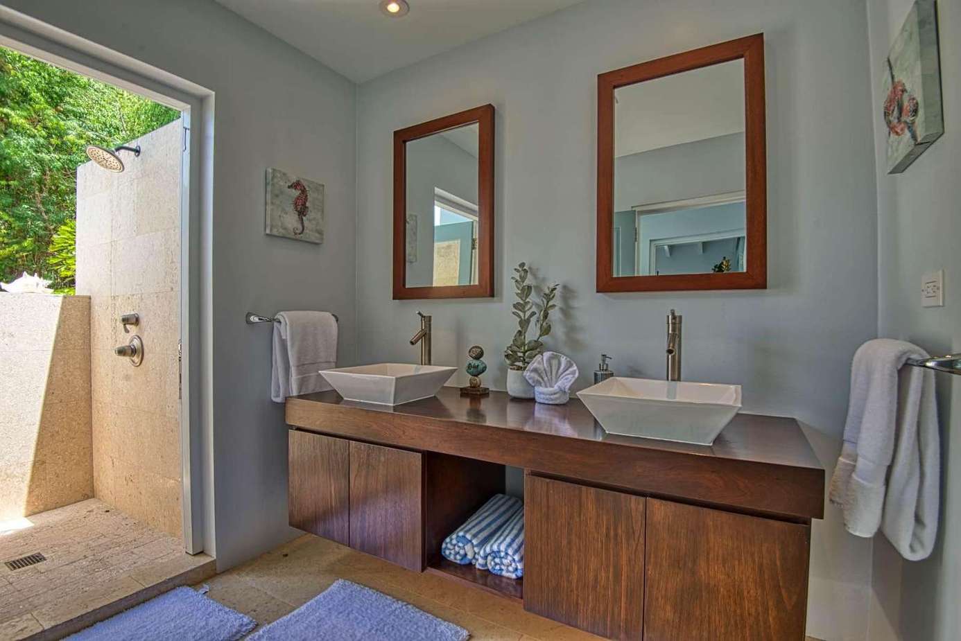Bright bathroom with dual sinks and private outdoor access
