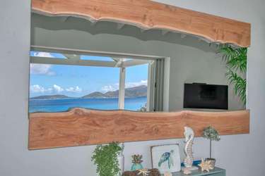 Coastal view reflected in stylish living room mirror