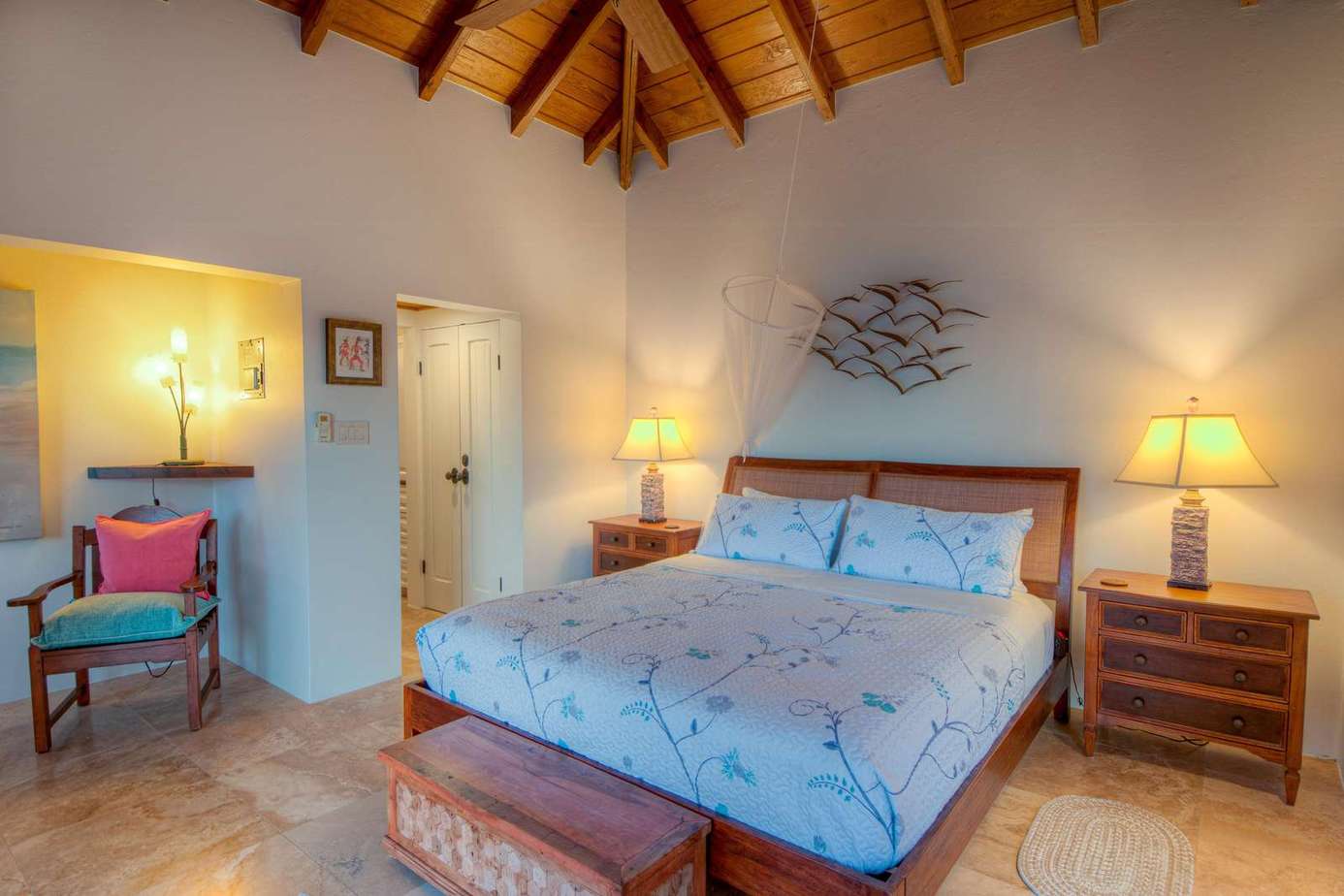 Cozy bedroom retreat with vaulted ceilings and warm lighting