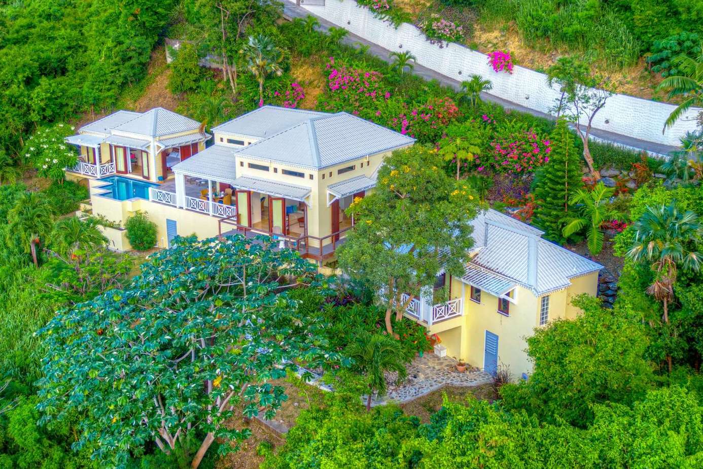 Secluded hillside retreat surrounded by lush greenery and vibrant gardens